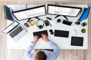 Overemployed Worker with 2 Screens and a Laptop